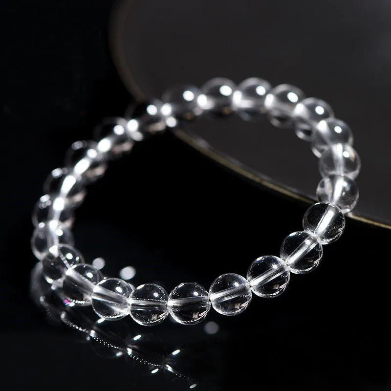 Natural old mine white crystal round bead bracelet with geometric style on a wrist.