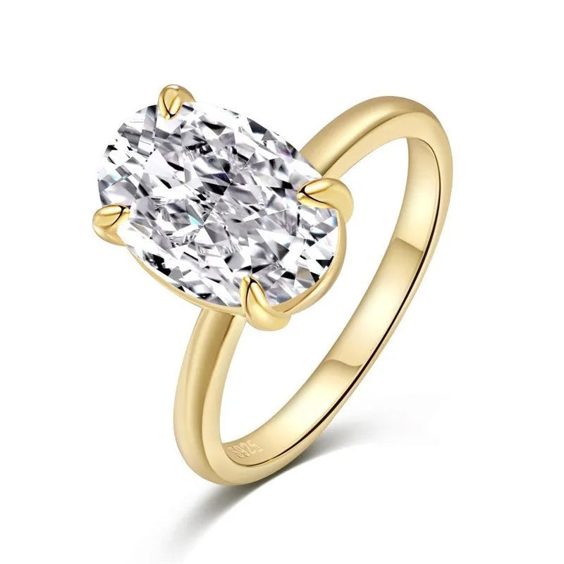 A women's oval sterling silver ring with a four-claw setting holding a single stone.