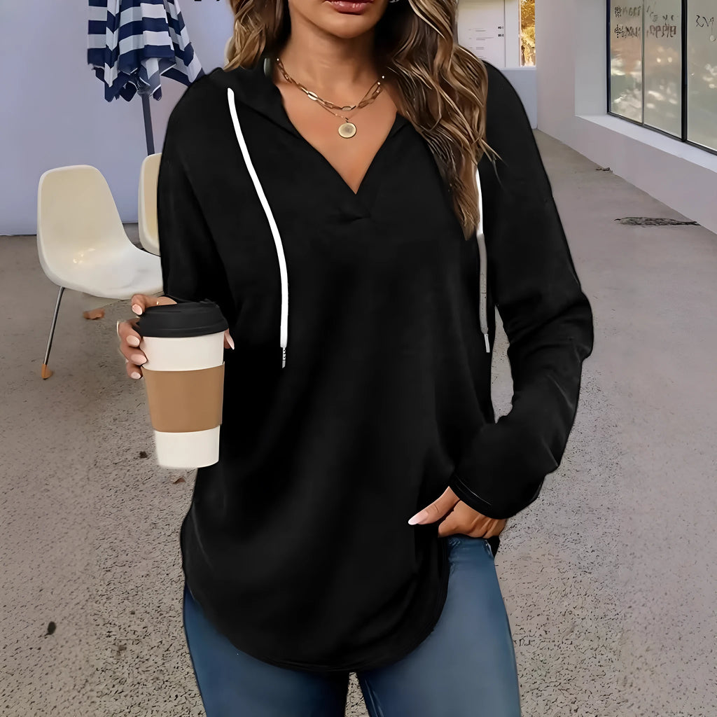 Women's loose fit black hooded V-neck sweatshirt with long sleeves on a hanger.