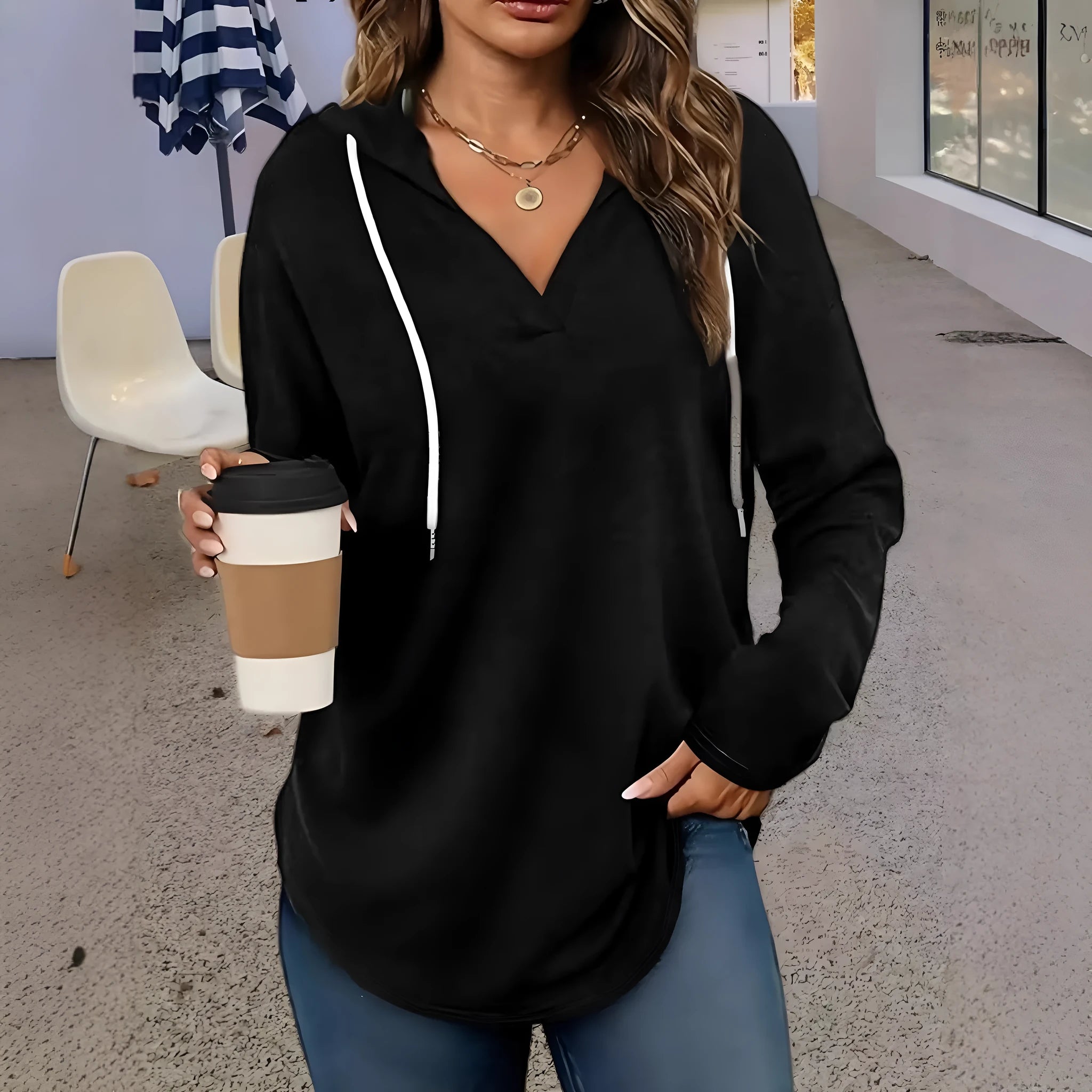Women's loose fit black hooded V-neck sweatshirt with long sleeves on a hanger.