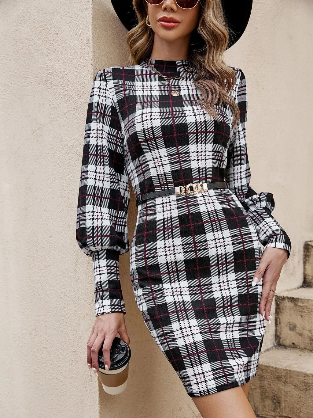 A black tight-fitting midi dress with loose lantern sleeves and decorative leather stitching on the front.