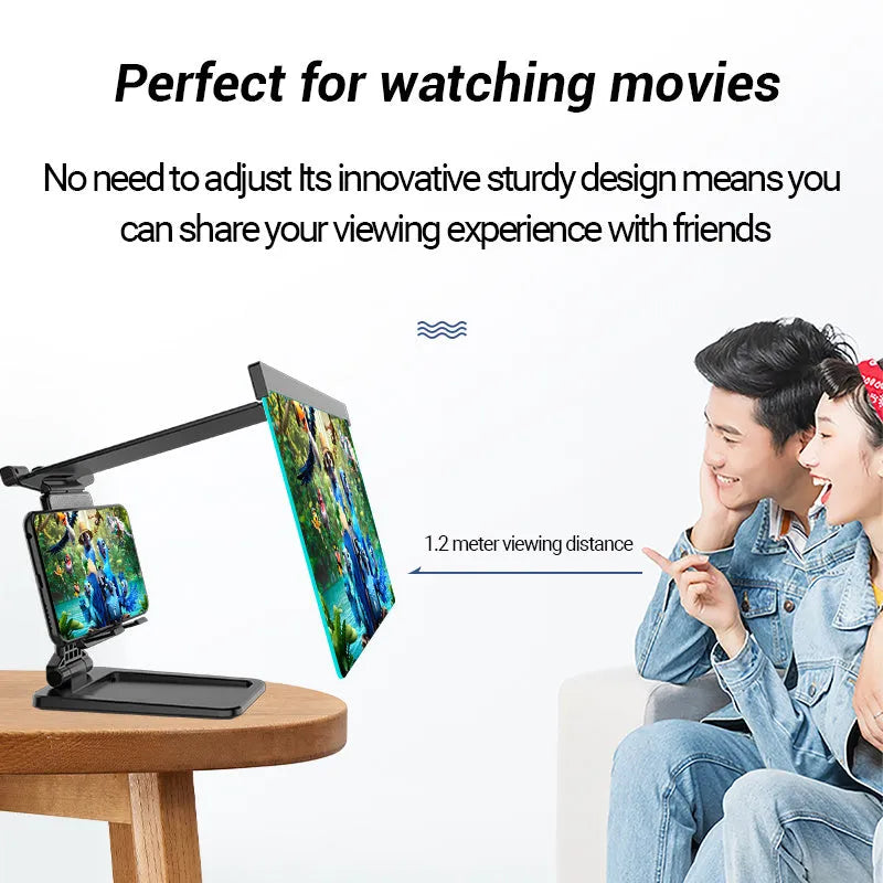 Black foldable mobile phone screen magnifier with detachable phone holder shown on a desktop.