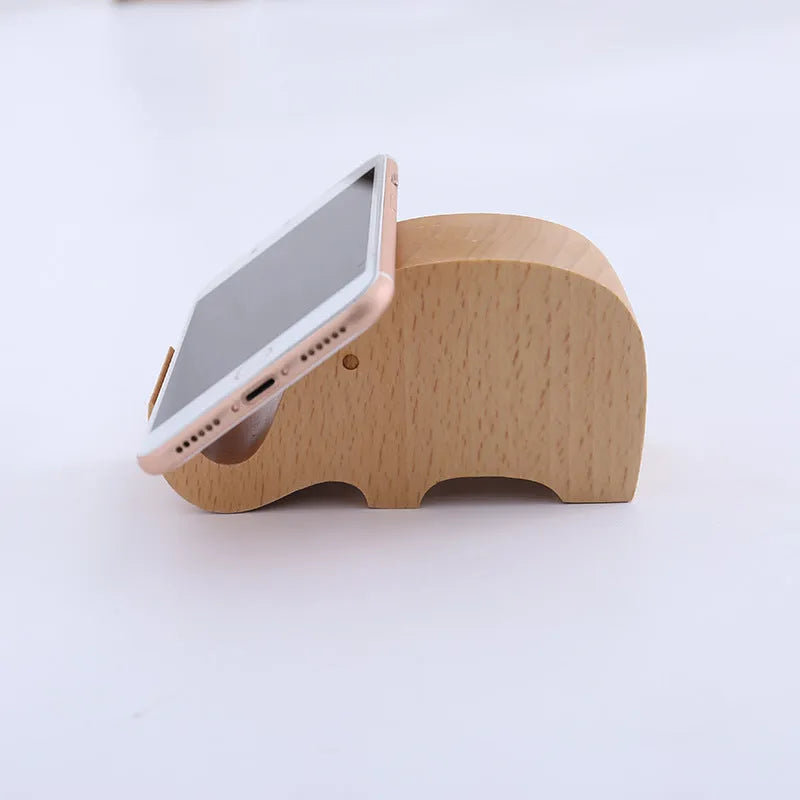 Solid beech wood phone holder with resin puppy decoration and a pound coin in the integrated slot.