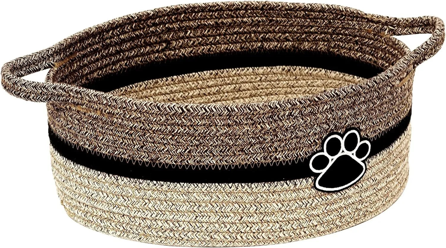 Light beige handmade cotton rope storage basket with handle on a wooden surface.