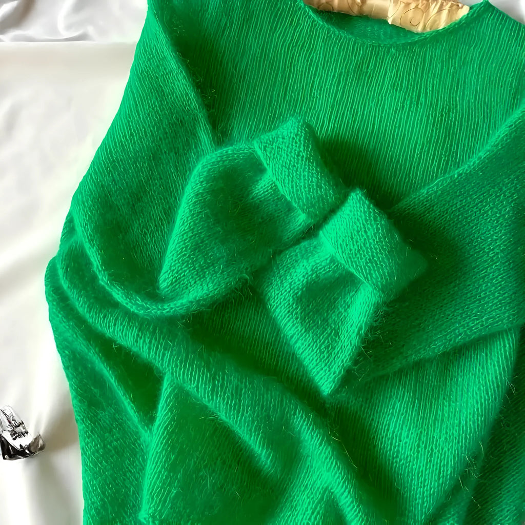 Green crew neck loose fit long sleeve polyester pullover sweater for women on plain background