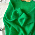 Green crew neck loose fit long sleeve polyester pullover sweater for women on plain background