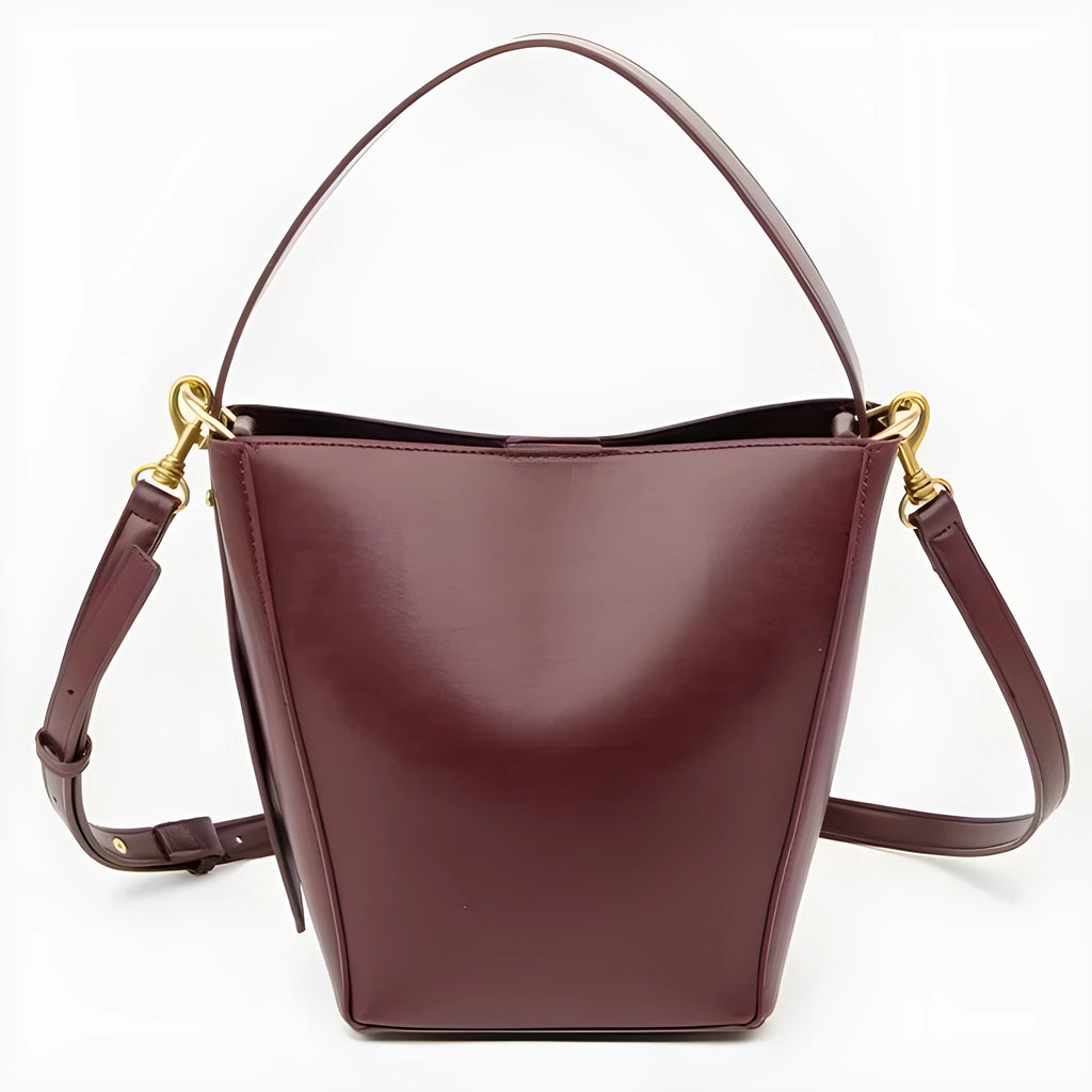 Urban minimalist bucket-style crossbody shoulder bag in PU with three-dimensional outer pocket, black colour option, flat lay view