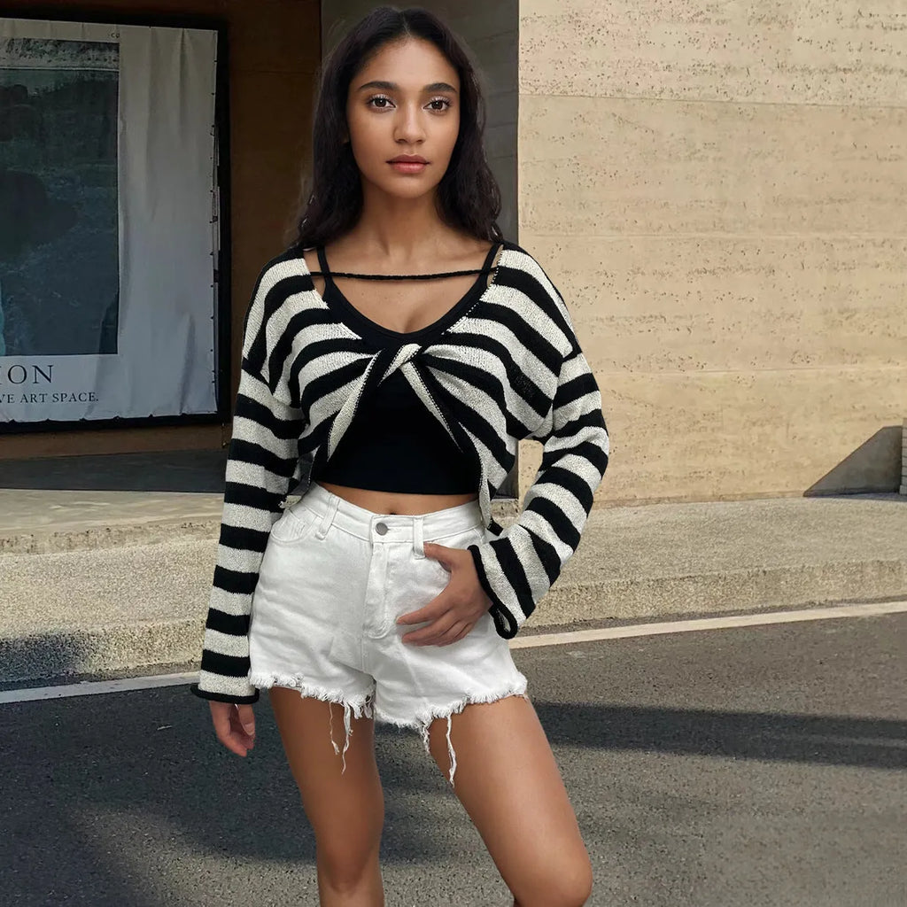 Woman wearing a striped long-sleeve sweater in mercerised cotton, showing front and back wearability with exposed navel detail.