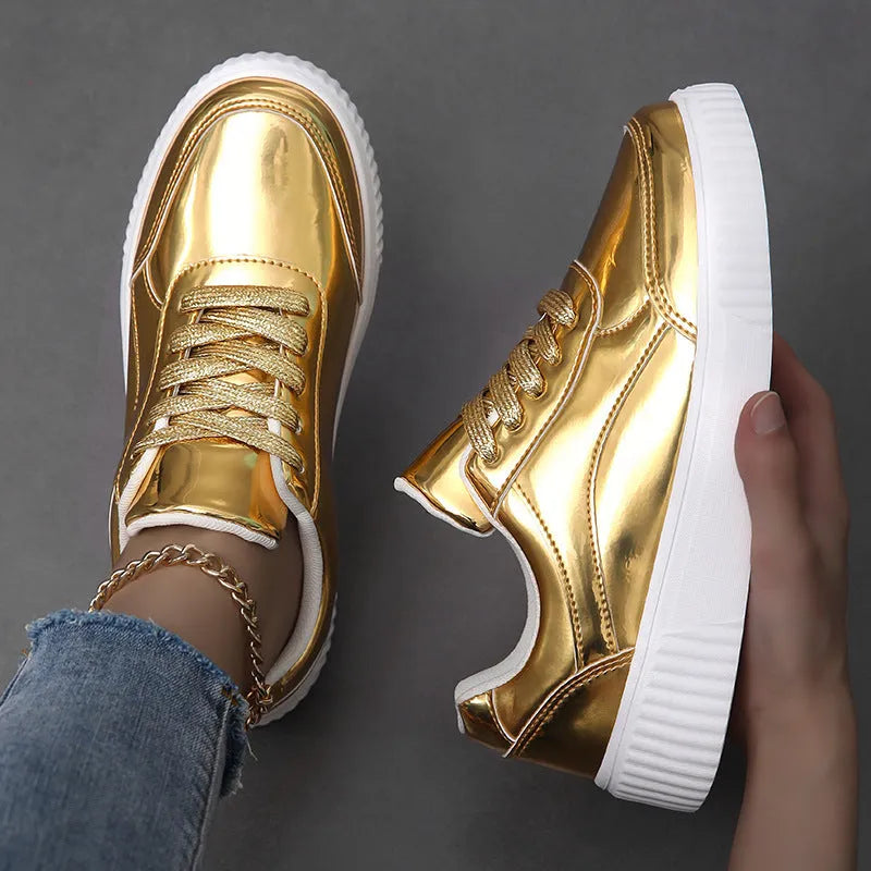 Gold sequinned platform sneakers with thick sole and round toe on a white background.