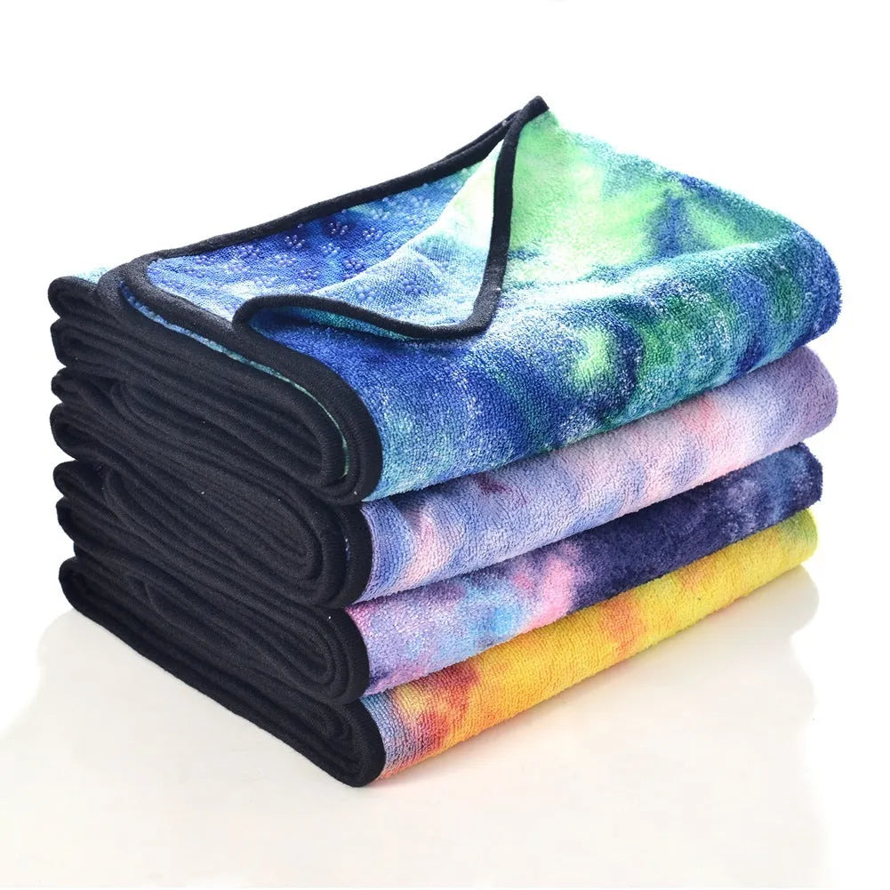Tie-dyed blue microfiber non-slip yoga mat towel measuring 63x183cm on a yoga mat