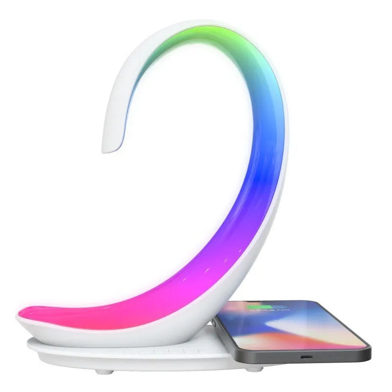 White swan-shaped desktop device functioning as a wireless charger, Bluetooth speaker, and colourful LED atmosphere lamp.