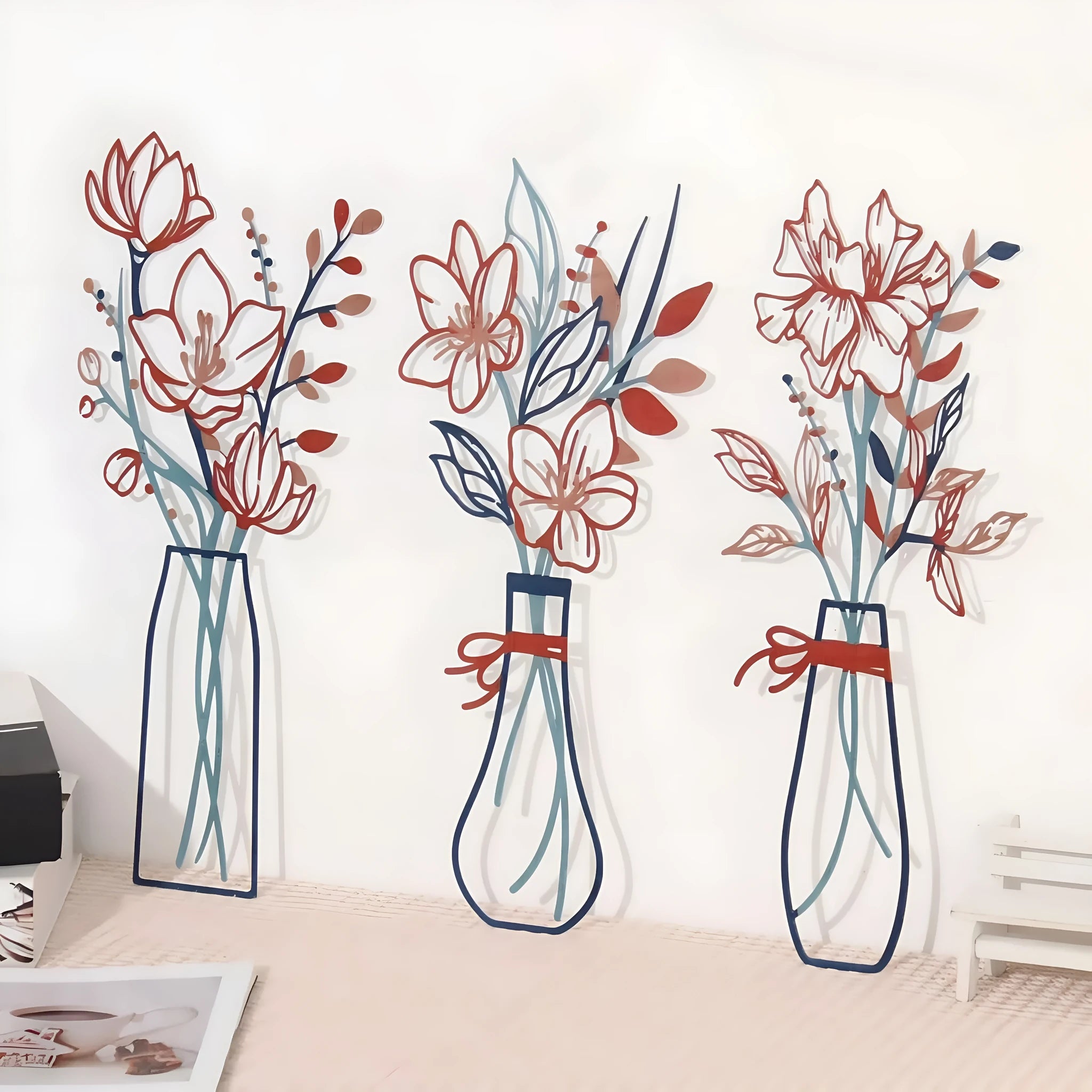 Three metal floral wall art plaques with vase designs in modern farmhouse style