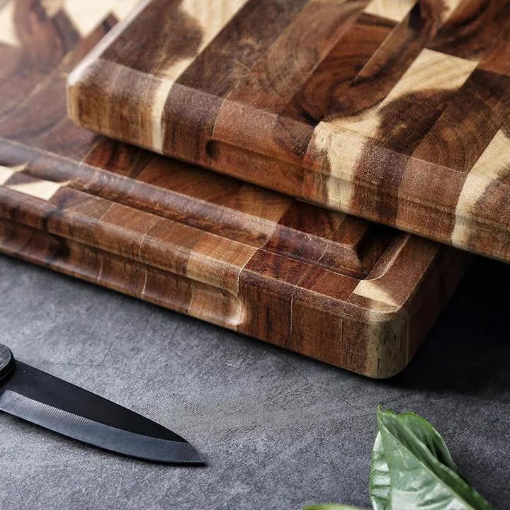 Brown parquet-pattern solid wood chopping board with 3cm thickness on a kitchen counter.