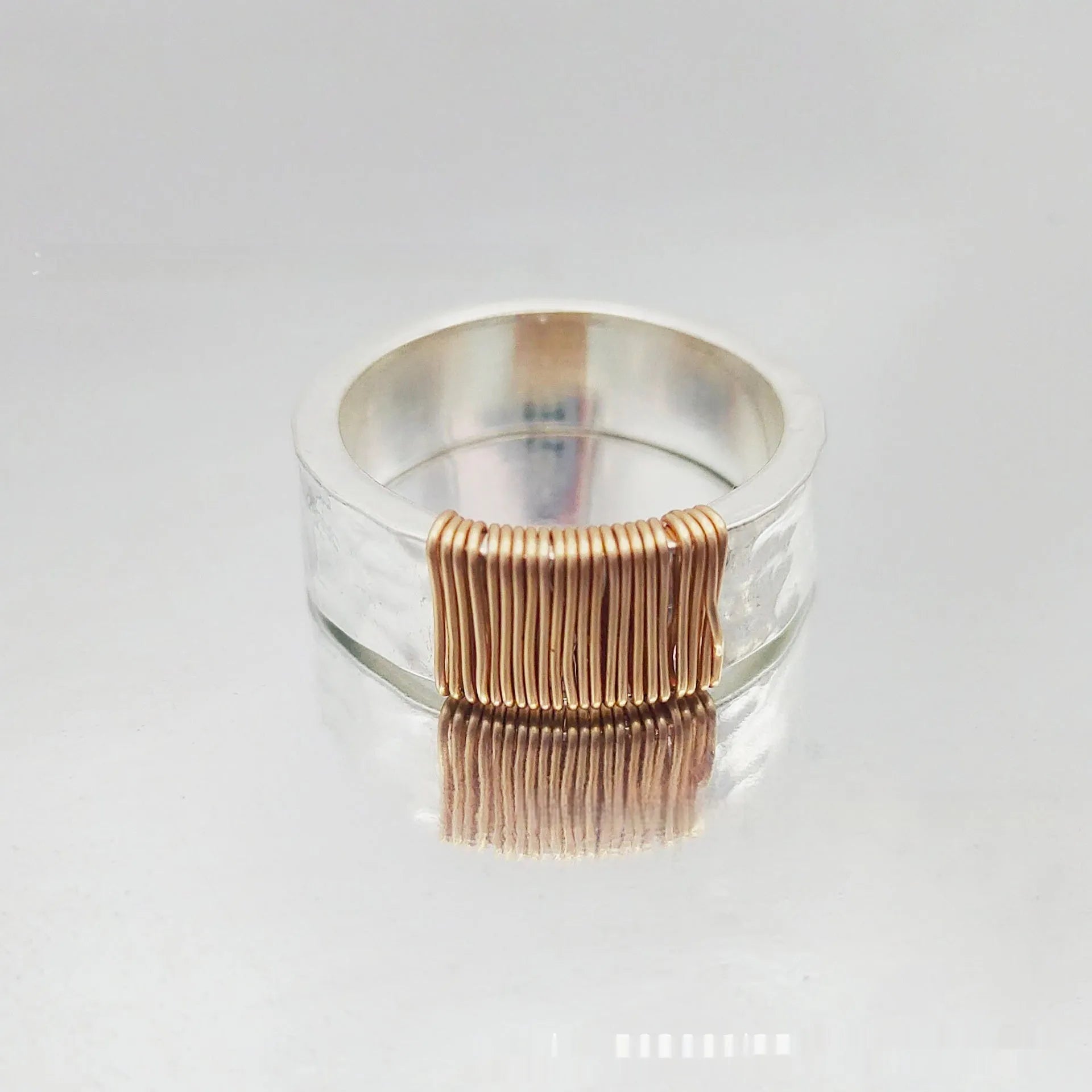 Copper geometric wide ring bracelet with irregular coil design in silver-gold colour.