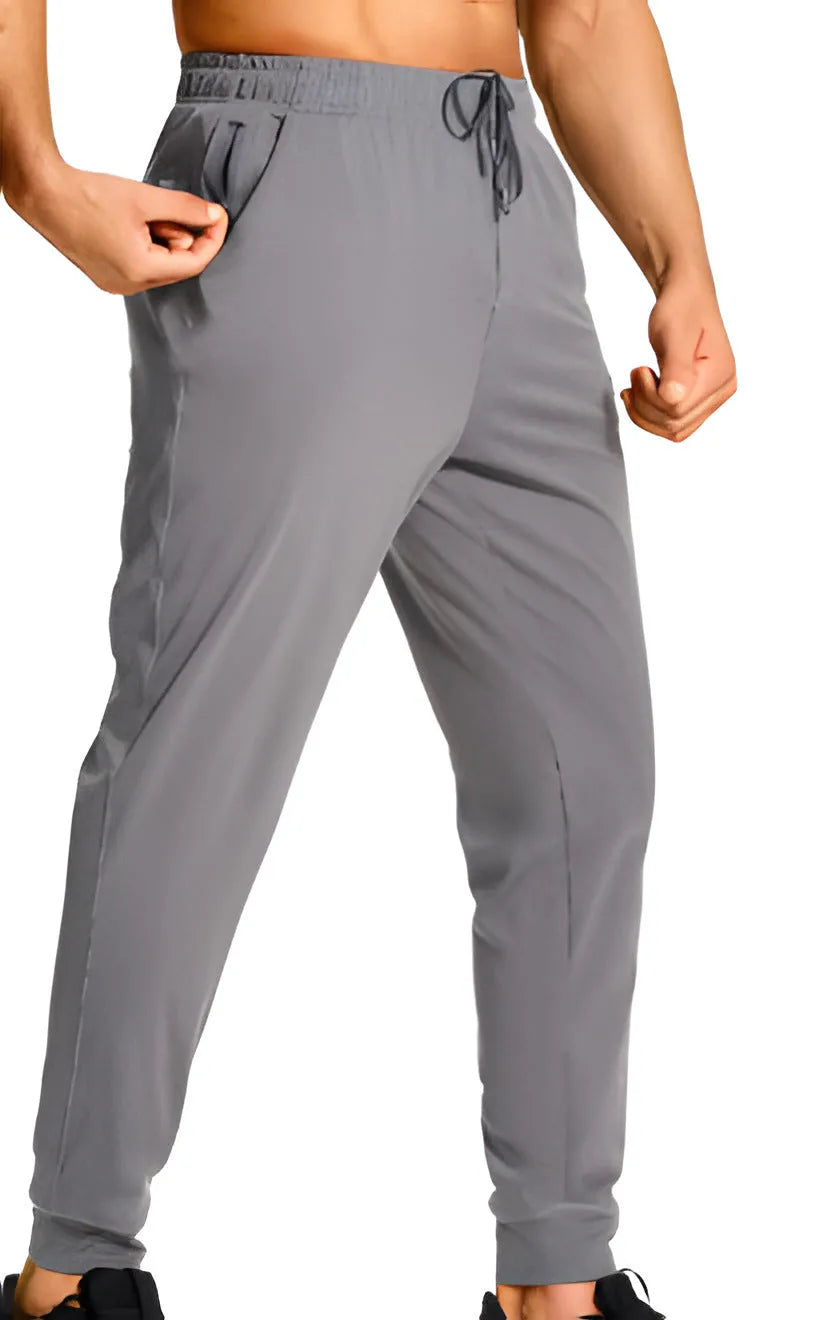 Men's loose fit solid colour casual trousers in polyester fabric on a hanger