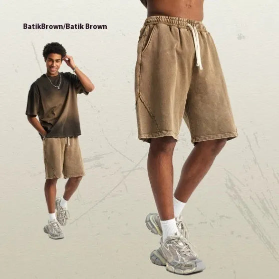Men's batik-washed cotton terry shorts in loose fit shown in Batik Black colour