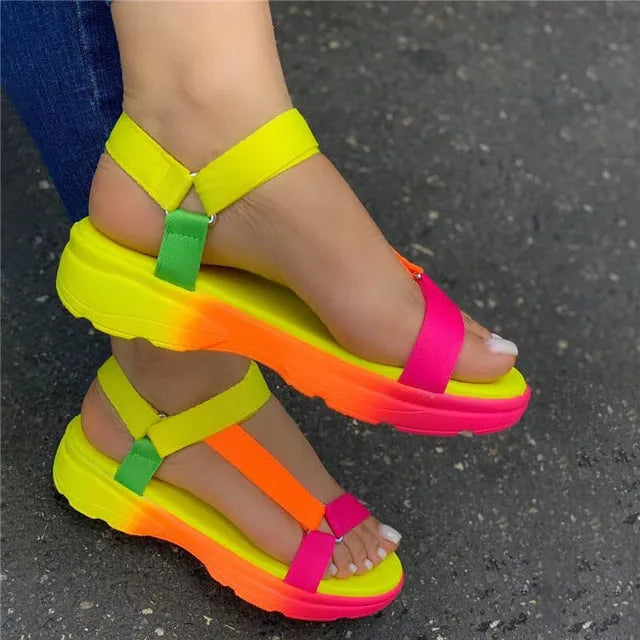 Fish mouth sandals with artificial leather upper, flat heel, and belt buckle fastening, shown in black