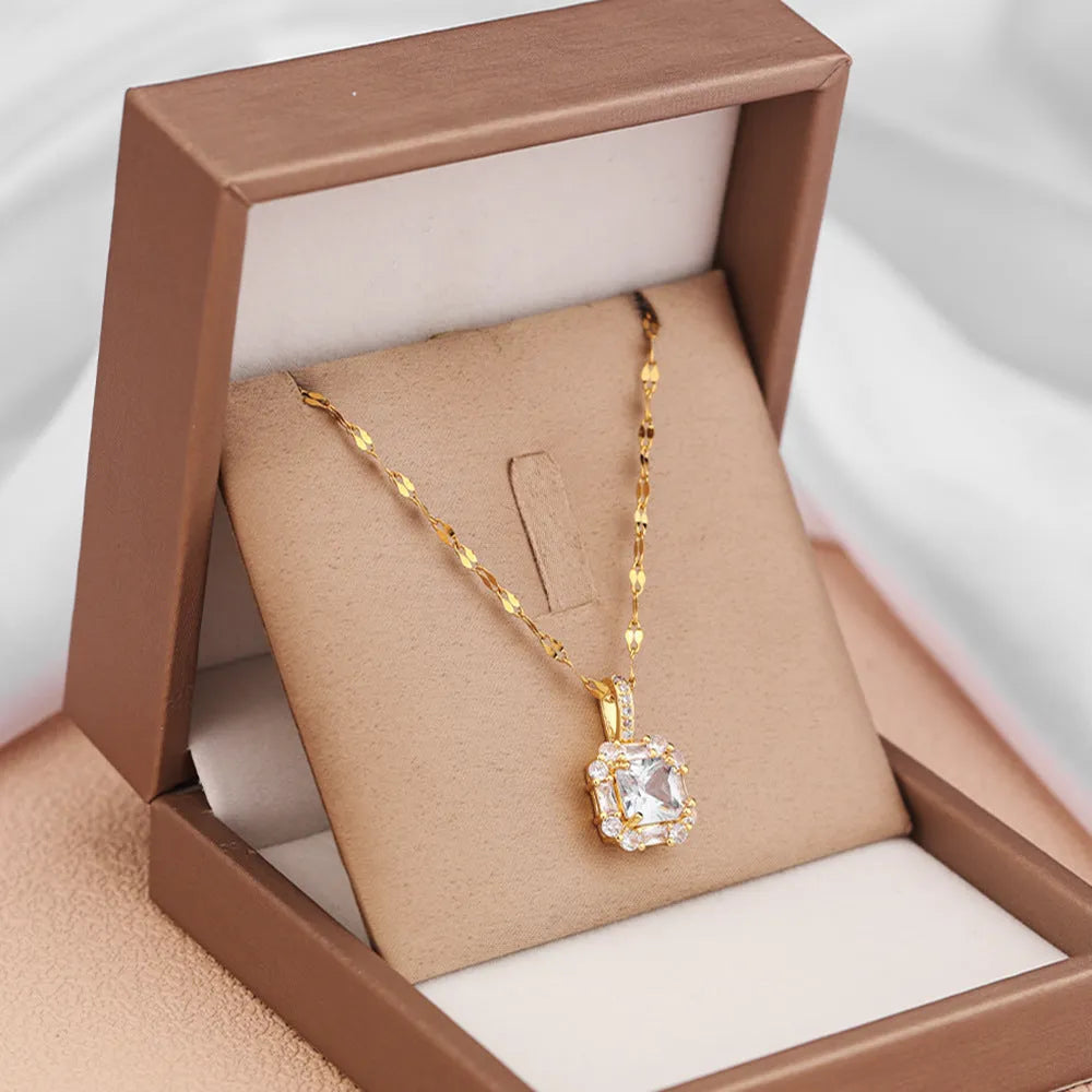 Gold geometric quadrilateral pendant with mixed gem inlays on titanium steel water wave chain necklace