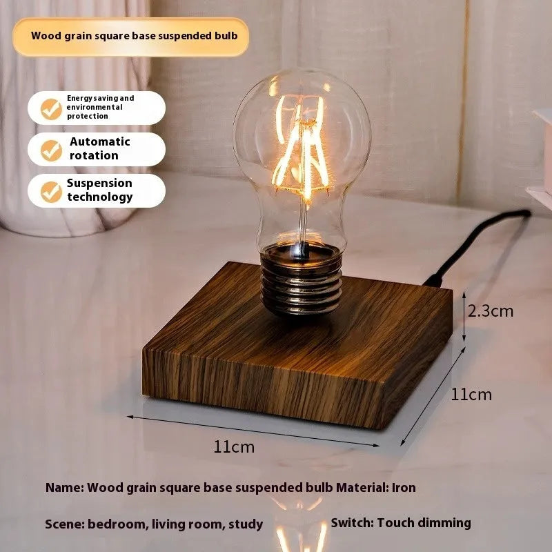 Iron art suspension bulb desktop night lamp on a black square base.