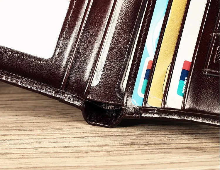 Open view of a black men's leather bifold wallet showing card slots, photo window, and zipped coin pocket.
