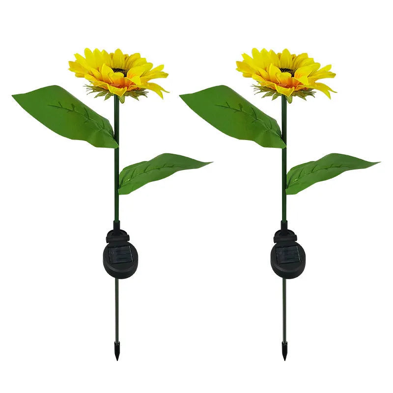 LED solar sunflower lamp with yellow fabric flower head, 66cm stainless steel stem, and ABS ground plug, placed on grass
