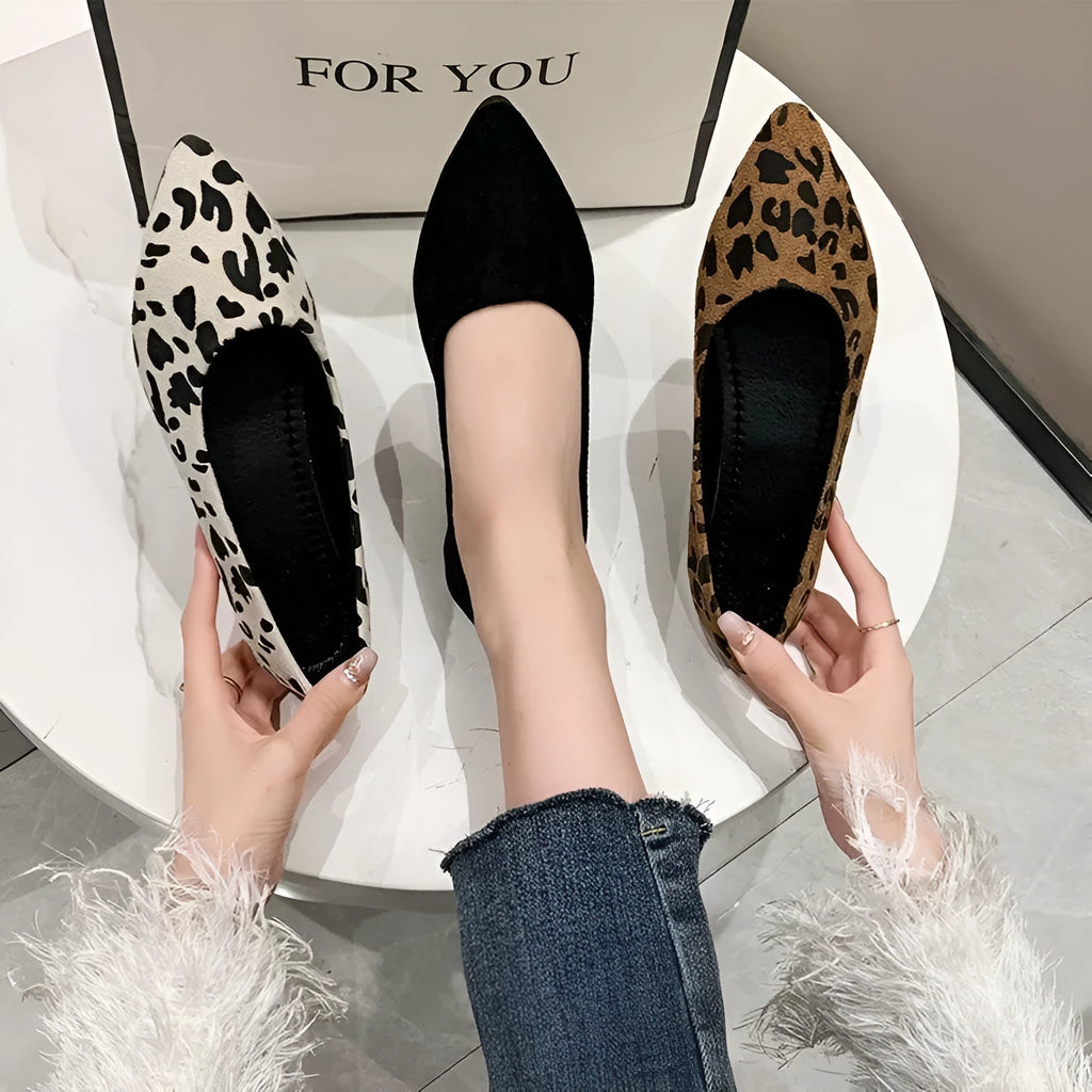 Women's leopard print flat pumps with a pointed toe, low heel, and cotton upper on a rubber sole.