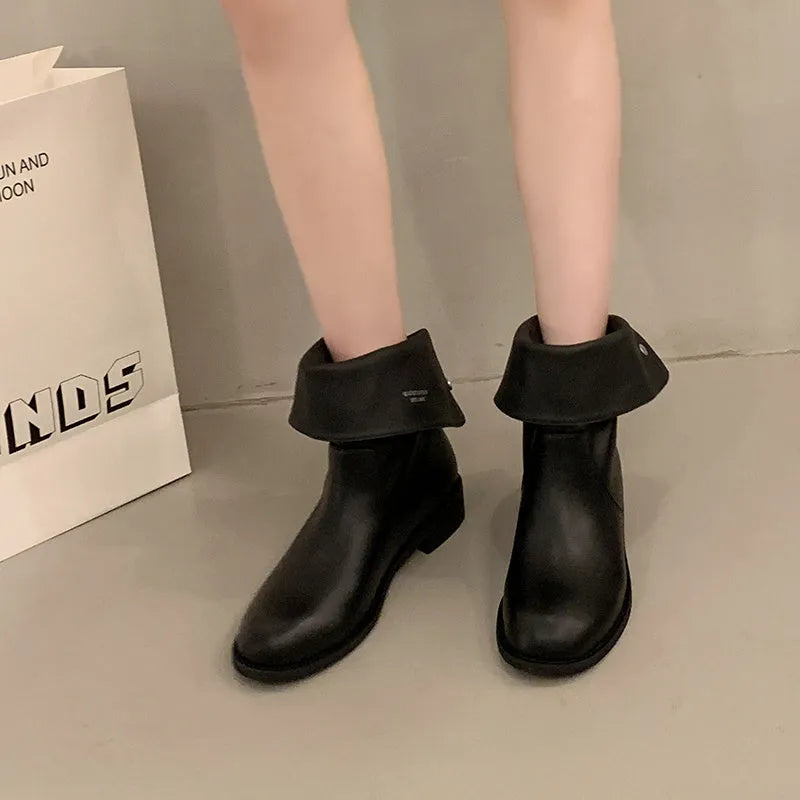 Women's black leather mid-calf platform boots with silver stud details on a white background