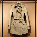 Khaki double-breasted trench coat for women with long flight sleeves, shown on a hanger.