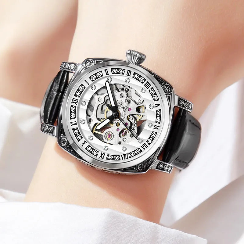 Mechanical analogue watch with luminous hands and a leather strap, shown in multiple colour options.