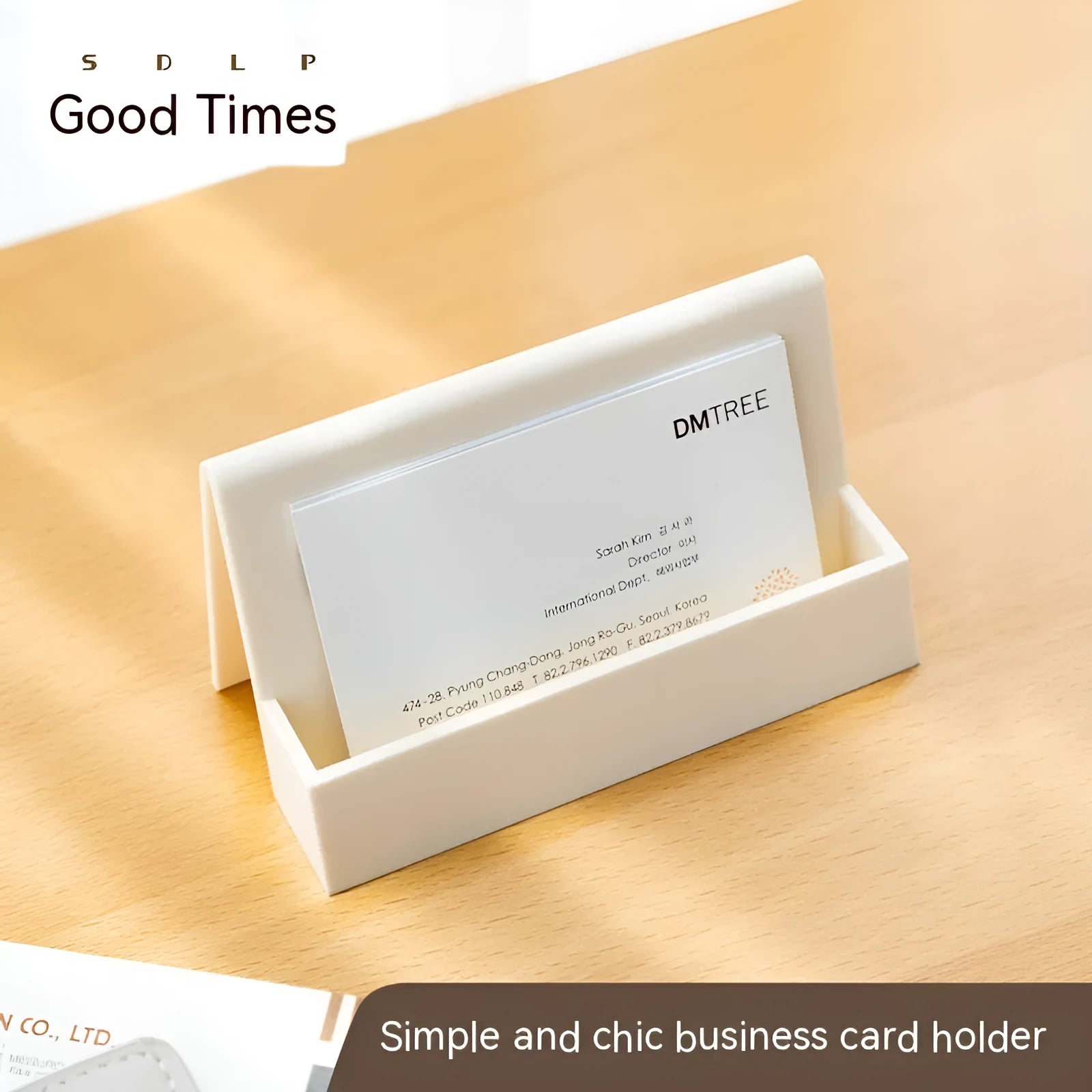 Creative PS geometric business card stand in brown, holding 20 cards upright on a desk.