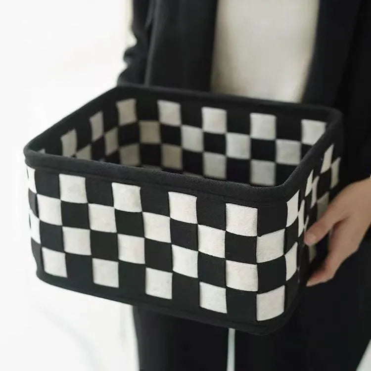 Grey and white checkerboard woven felt storage basket with folded sides, showing dimensions of 37cm by 29cm.