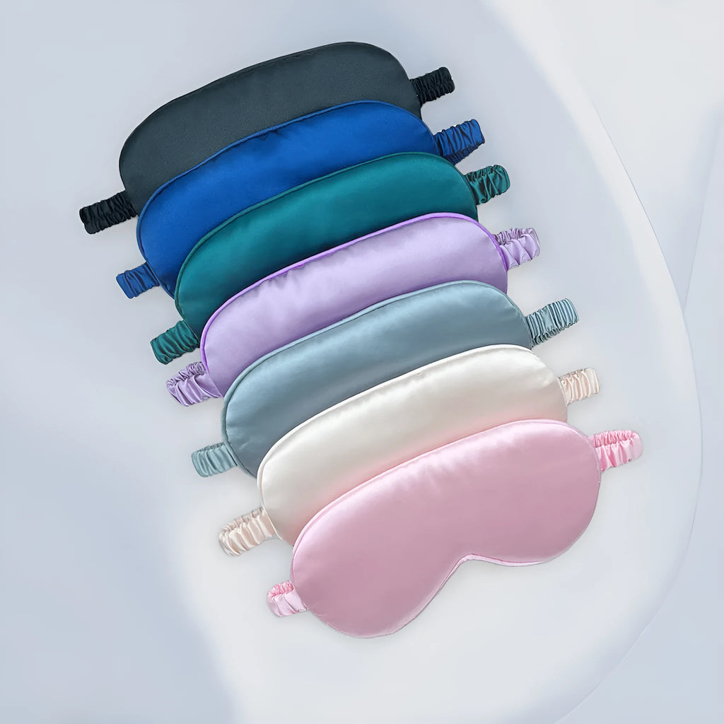 Rayon satin double-sided sleep mask in a selection of solid colours on a white background.