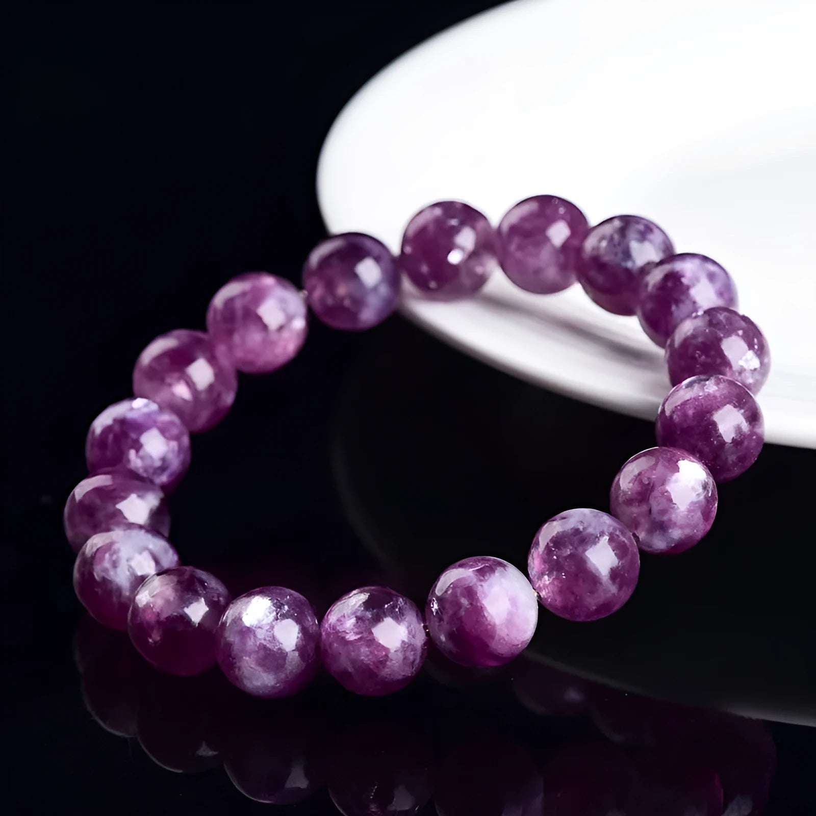 Polished purple and pink crystal grandmother bracelet with geometric beads on a wrist, showing Korean-style unisex design.