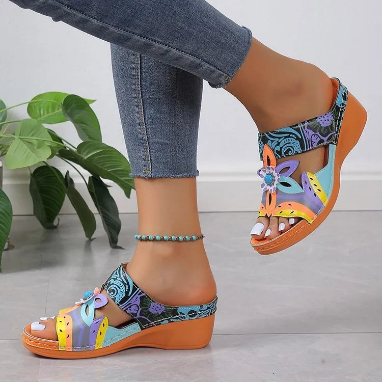 Ethnic patterned cowhide slippers with a rounded toe and rubber sole in multiple colours.