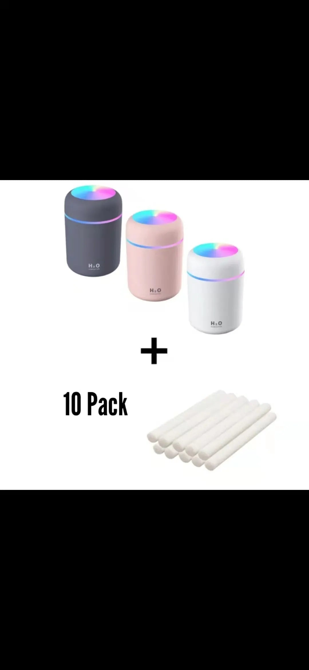Pink USB mini humidifier with LED lights on wooden desk beside laptop