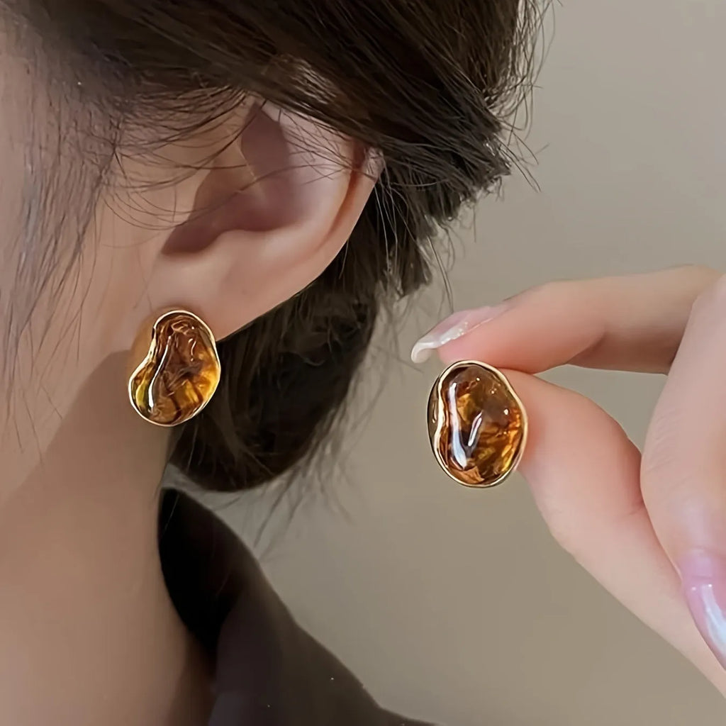 Set of three pairs of geometric alloy holiday ear studs with tassels in different styles.