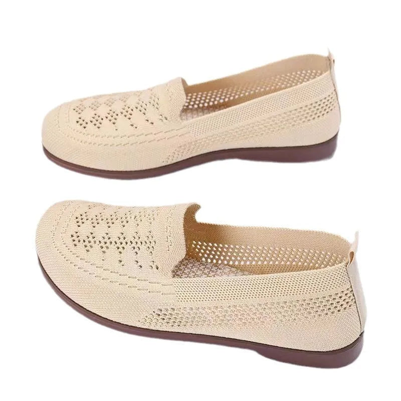Beige casual tennis shoes for women with mesh upper and antiskid sole on a plain background.
