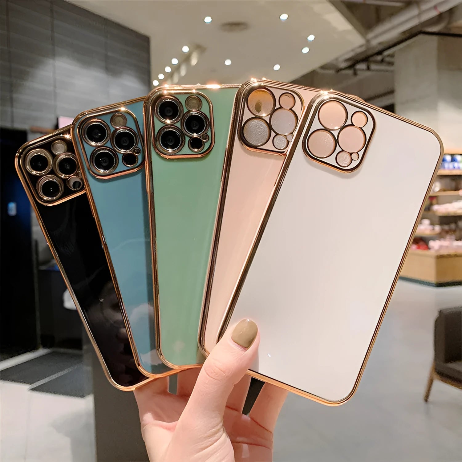Luxury solid colour electroplated mobile phone case for iPhone 13 series on a table.