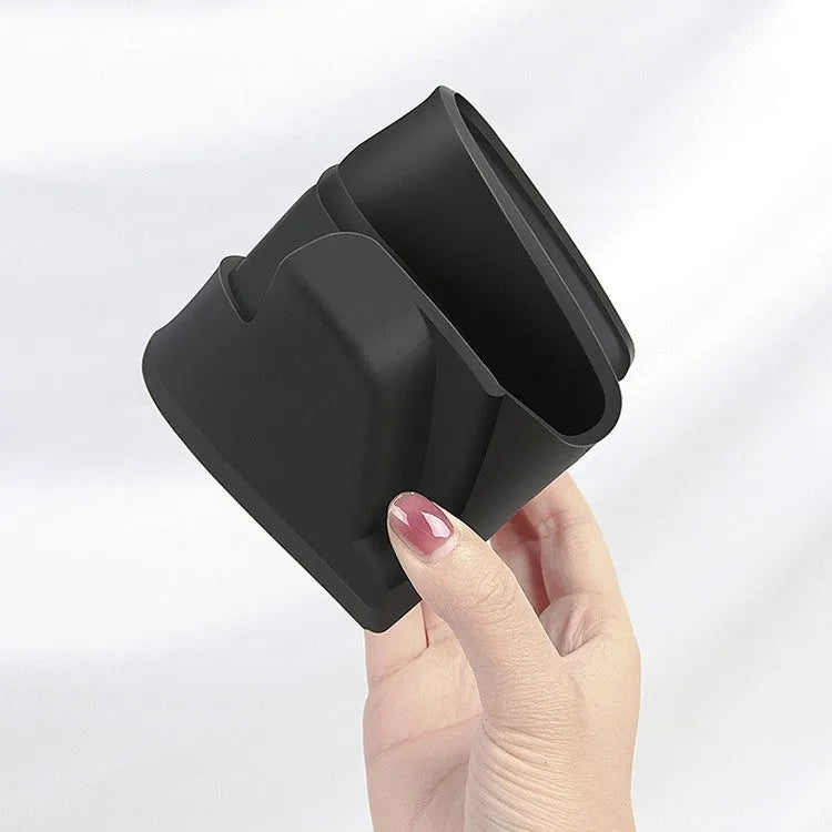 Black silicone glasses case installed inside a Tesla Model 3 or Y centre console armrest.