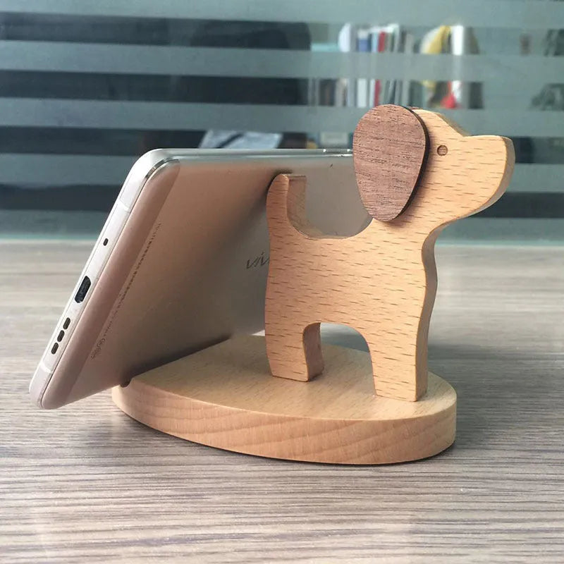 Solid beech wood phone holder with resin puppy decoration and a pound coin in the integrated slot.