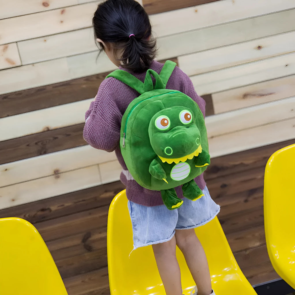 Children's dinosaur plush backpack with embroidered detailing and soft handle in blue colour