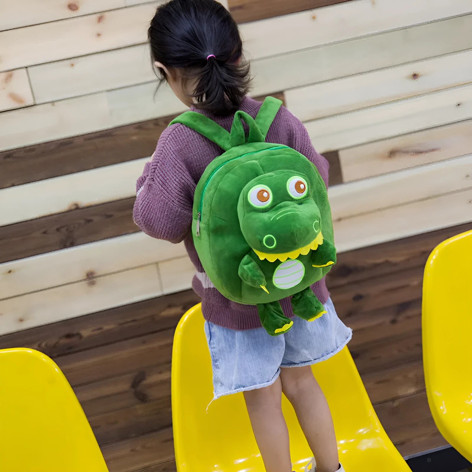 Children's dinosaur plush backpack with embroidered detailing and soft handle in blue colour
