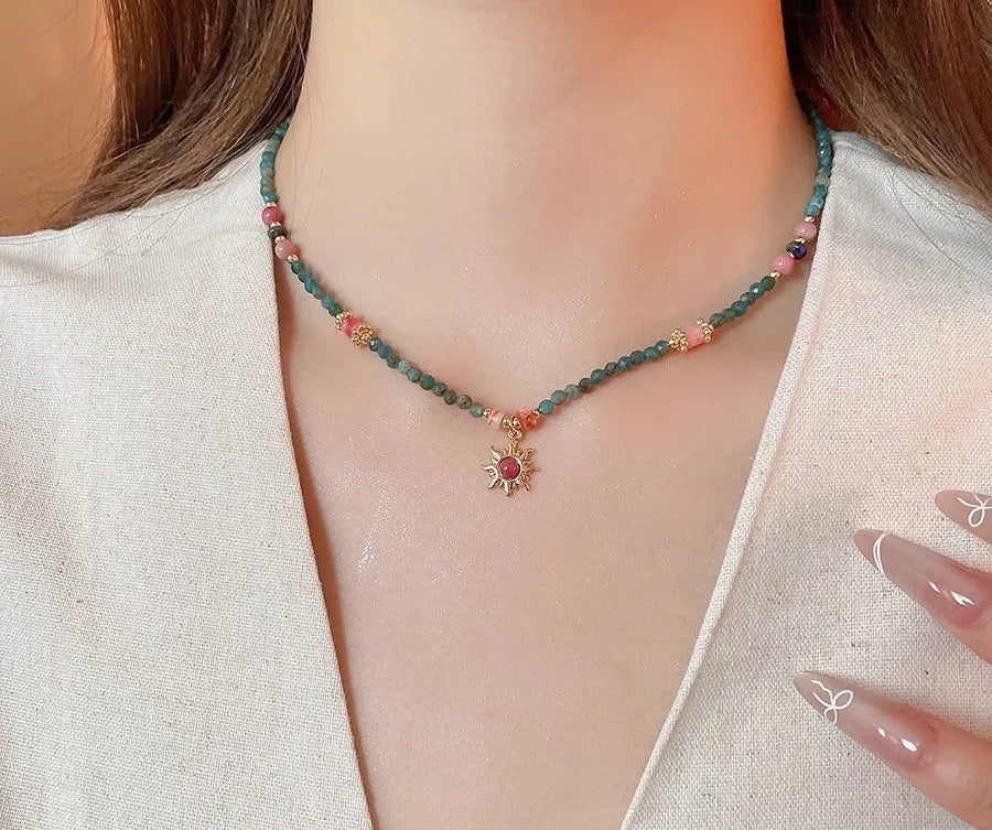 Freshwater pearl necklace with blue sun stone pendant on an adjustable clavicle chain.