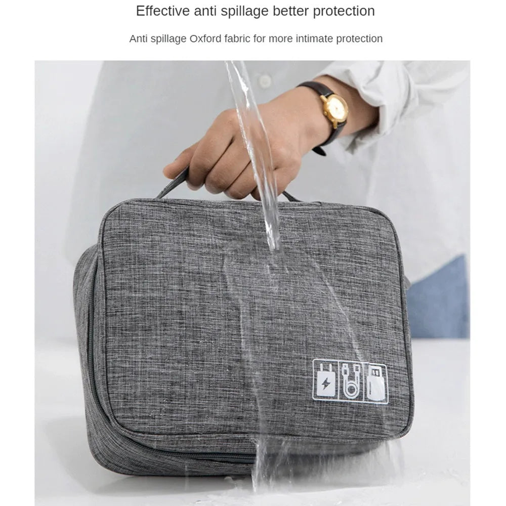 Black travel cable organiser bag with removable dividers and mesh pockets for electronic accessories