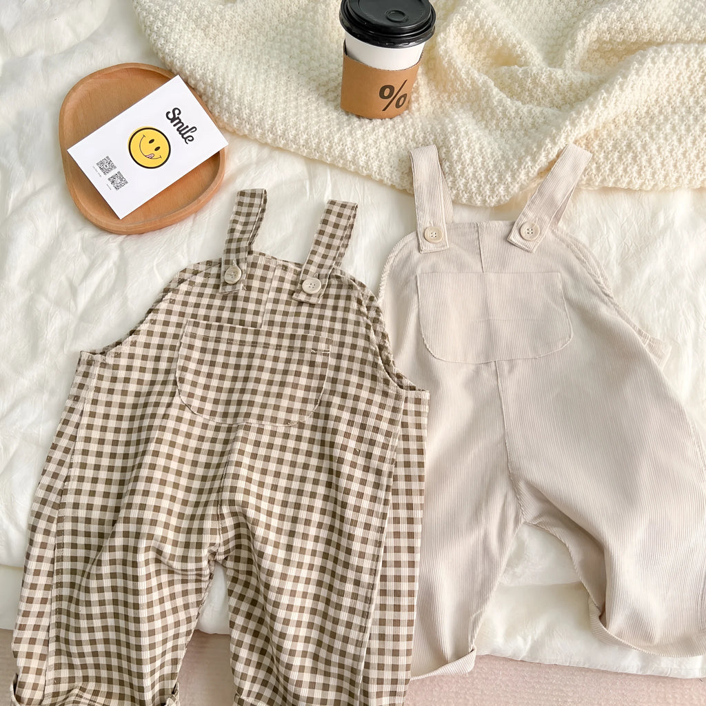 Unisex corduroy suspender overalls in creamy-white or brown plaid, with large pockets and double-breasted closure, for spring and autumn.