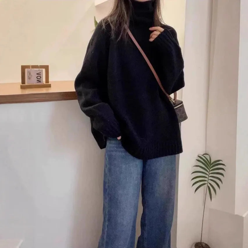 Women's thick grey turtleneck sweater with a textured curling pile collar, loose casual fit.