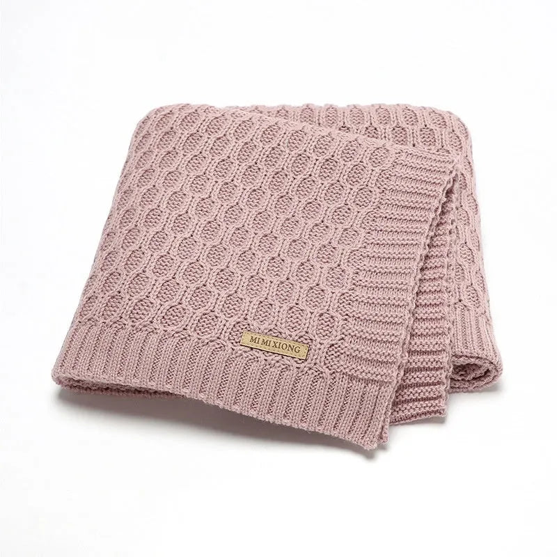 Solid colour infant hug blanket with three-dimensional lines pattern in acrylic fabric.