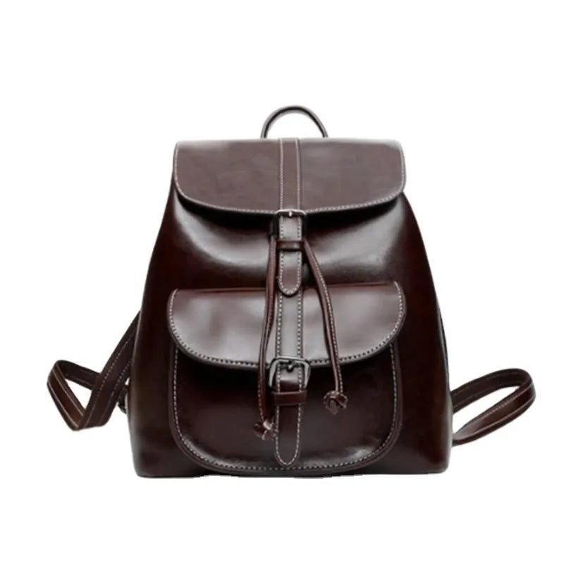 Korean style brown cowhide leather backpack with pull-belt fastening and front sandwich pocket.