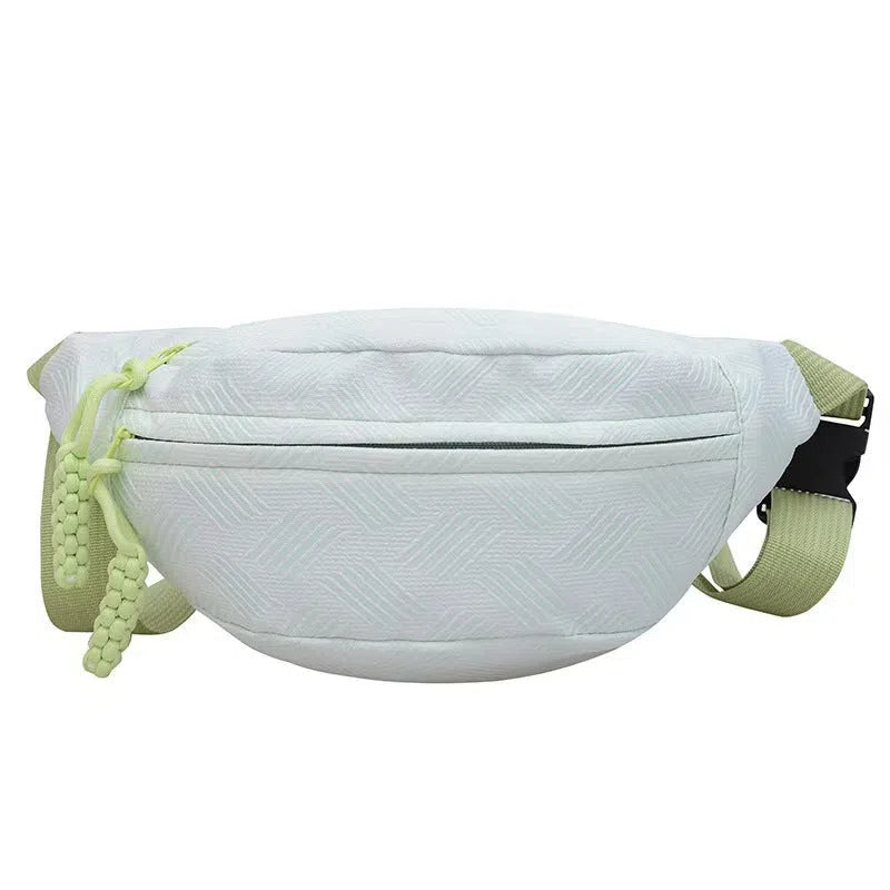 Nylon dumpling-shaped crossbody bag with single strap, zip hidden pocket, and inner patch pocket in pink, green, yellow, or purple.