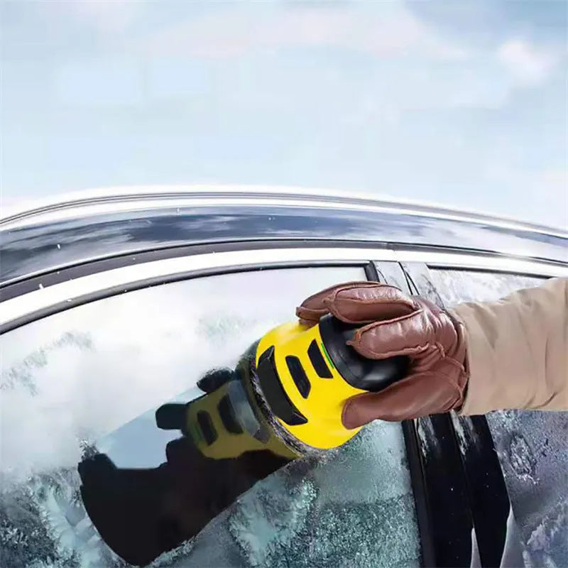 Yellow cordless electric car ice scraper with USB charging cable on a frosty car windscreen.